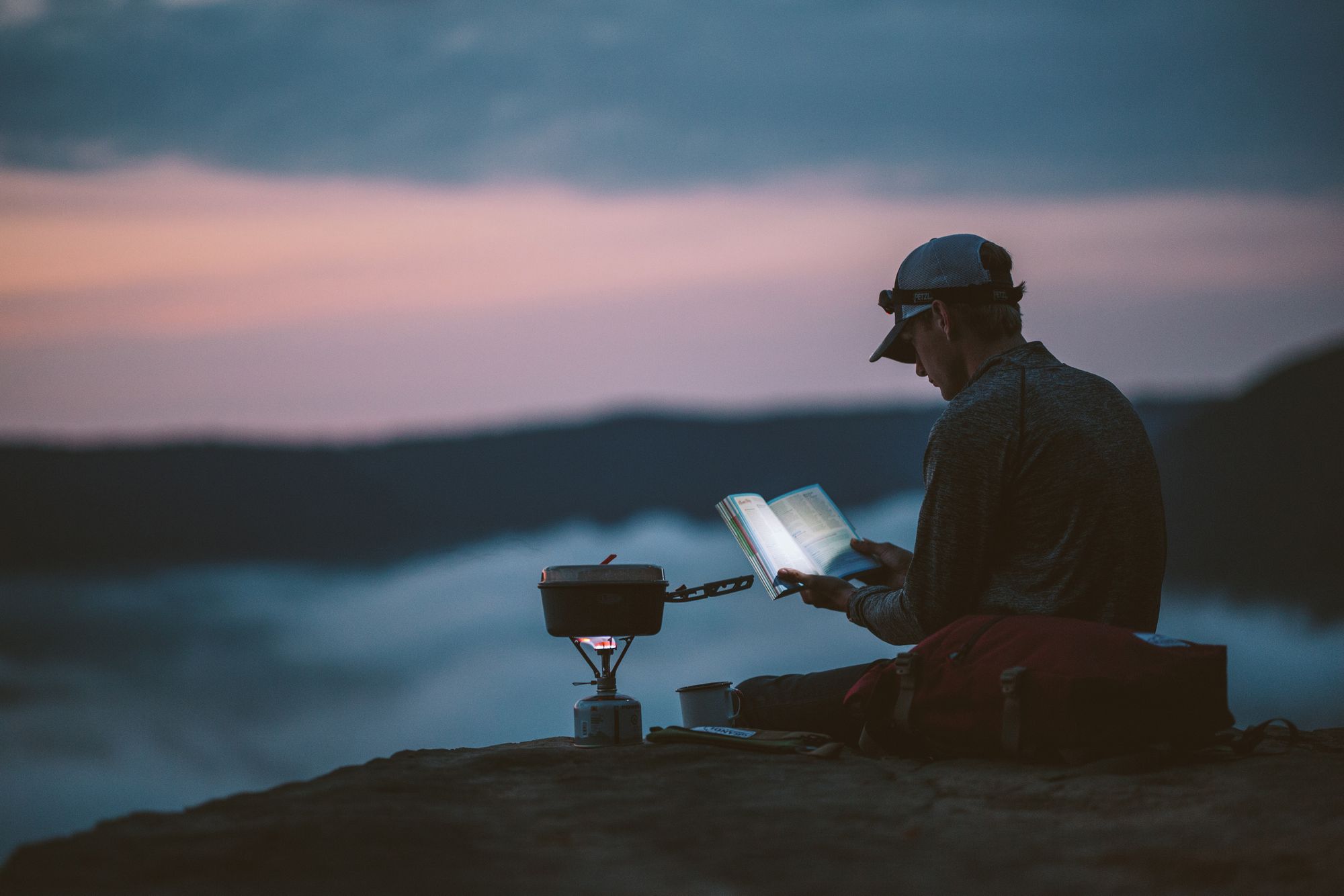 person reading a book in the wild